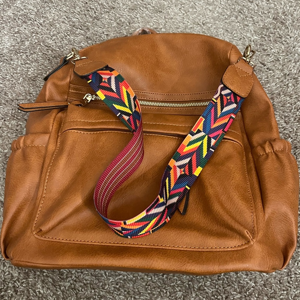 Faux leather backpack with multiple straps. Brand new